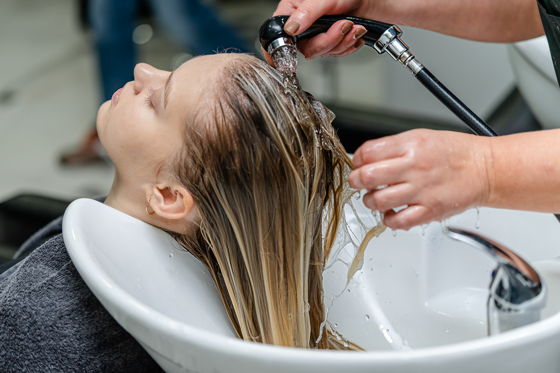 Hair stylist washing hair